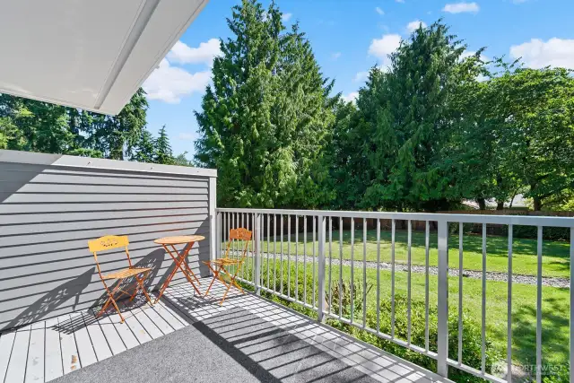 Private balcony deck off of living/dining area over looks shared fenced-in private yard area that is maintained by the HOA