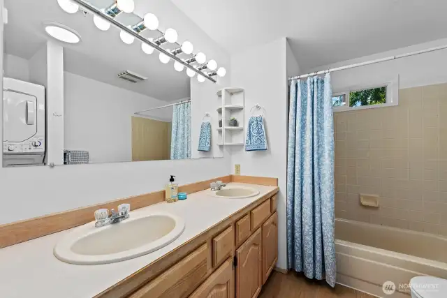 Full bathroom with stacking washer/drier