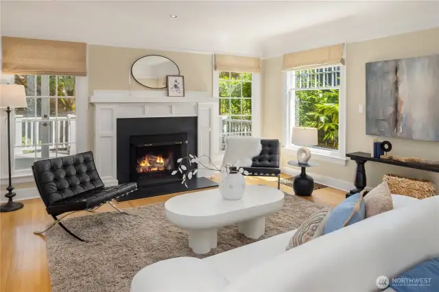 The inviting living room features a beautiful gas log fireplace and windows overlooking the back deck (perfect for al fresco dining!) and garden.