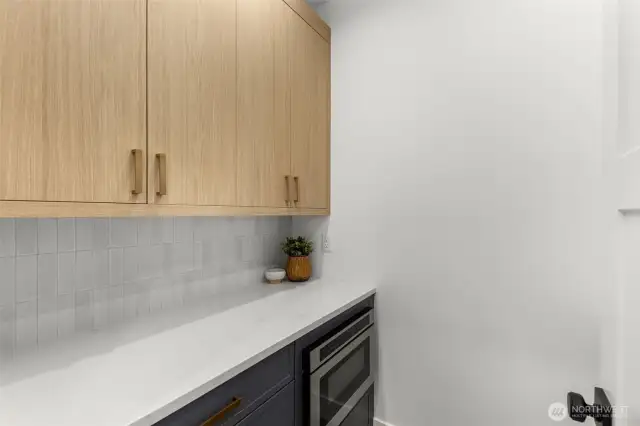 A spacious, hidden pantry offers an abundance of storage while keeping the kitchen clutter-free
