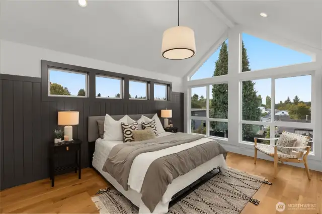 This primary bedroom is truly one of a kind with stunning floor-to-ceiling windows that flood the space with natural light.