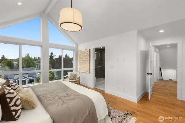 Not your average bedroom oversized glass panes bring the outdoors in and give this space serious wow factor.