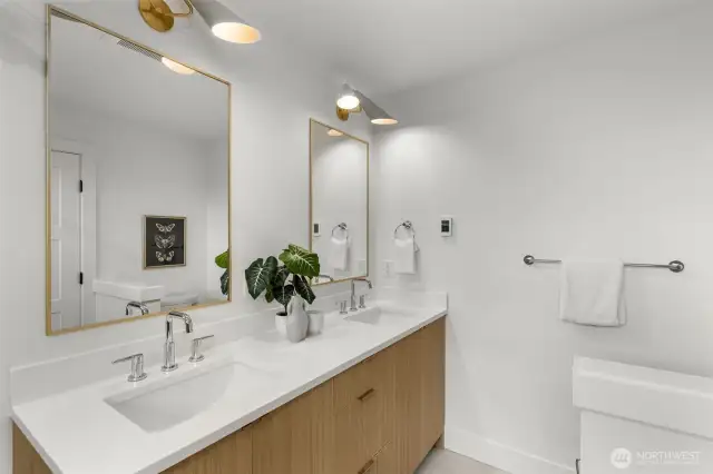 Dual vanities and statement lighting make getting ready feel like self-care.
