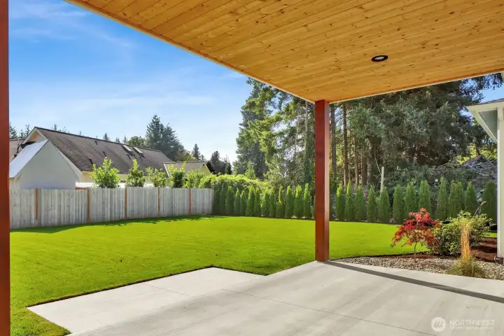 Look at this backyard! South-facing and sun-soaked, it features in-ground irrigation, partial fencing, and a covered patio—perfect for summer BBQs and evening hangouts.
