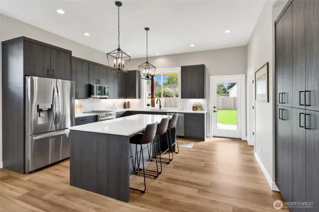 A chef’s dream kitchen with high-end finishes throughout, including Pental Quartz counters, soft-close High Craft cabinets, and a stylish subway tile backsplash. The island with eating bar and storage pantry make both cooking and entertaining a breeze.