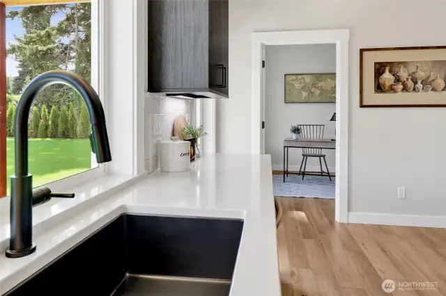 Doing dishes isn’t such a chore here—with a window above the sink, gorgeous finishes all around, and stylish pendant lighting overhead, even cleanup feels a little luxurious.