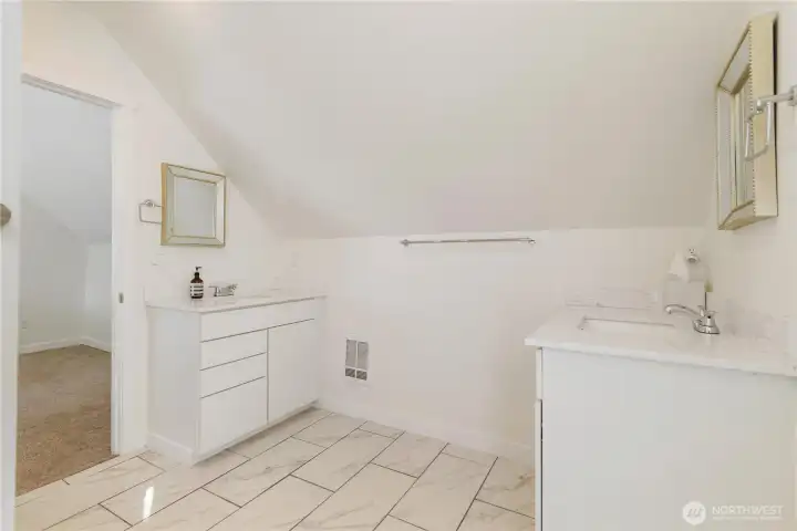 Upper level bathroom with separate vanities