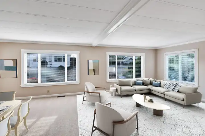 Formal living room area is open and bright! Large vinyl windows with plantation blinds bring in notable natural lighting all day.  Crown melding, updated ceiling, a neutral color scheme, professionally cleaned carpet are just some of the upgrades.
