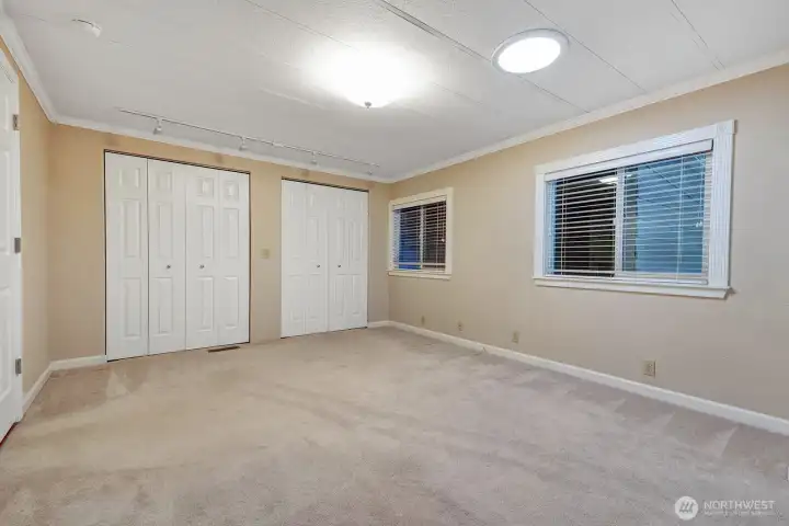 Guest bedroom has double closets with built in shelving Solar tube brings in natural light 24 hours.