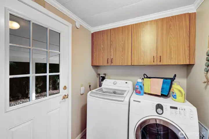 Utility room has access door to carport area, Cabinets for all your laundry necessities.
