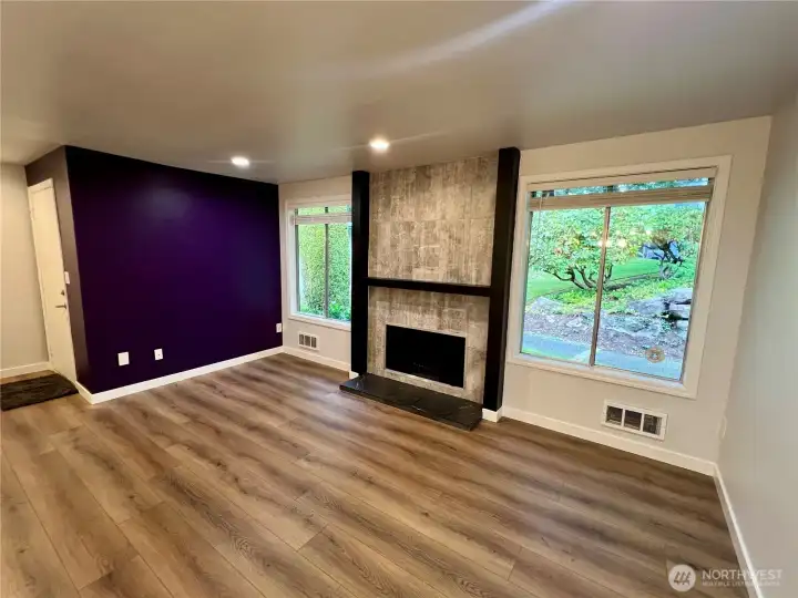 Large living room with beautiful wood-burning fireplace.
