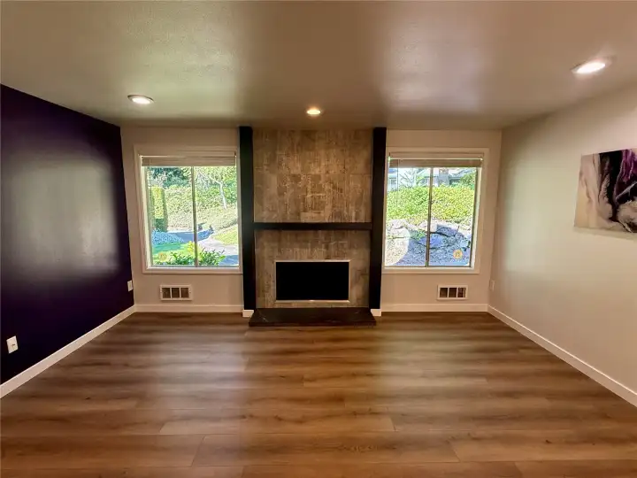 Large living room with beautiful wood-burning fireplace.