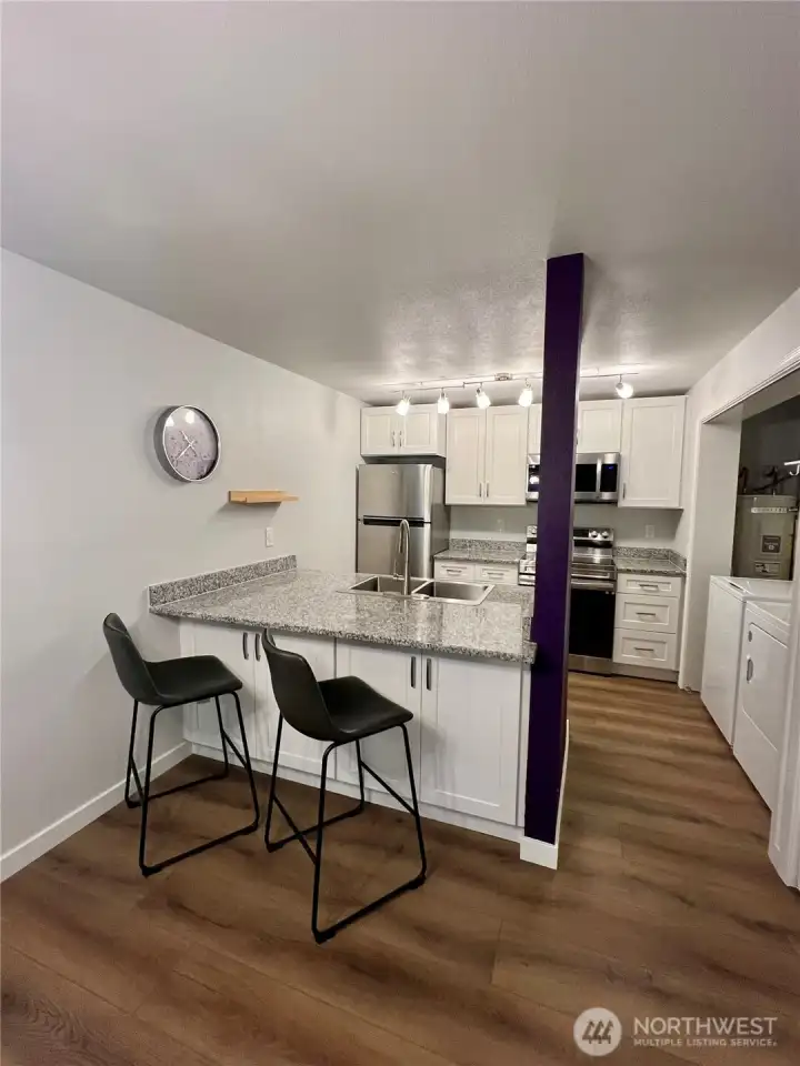 Updated kitchen with quartz countertops, new cabinets and stainless appliances.