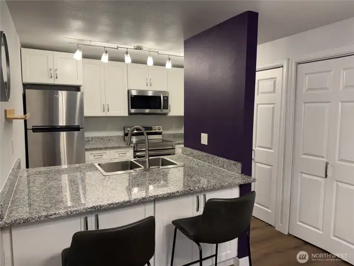 Updated kitchen with quartz countertops, new cabinets and stainless appliances.