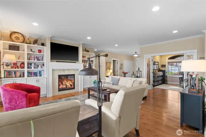 Looking from the living room, the office with its wide glass-paned double door entrance is straight ahead, a powder room and coat closet are to the left of the office, and the main entrance is next to the coat closet.
