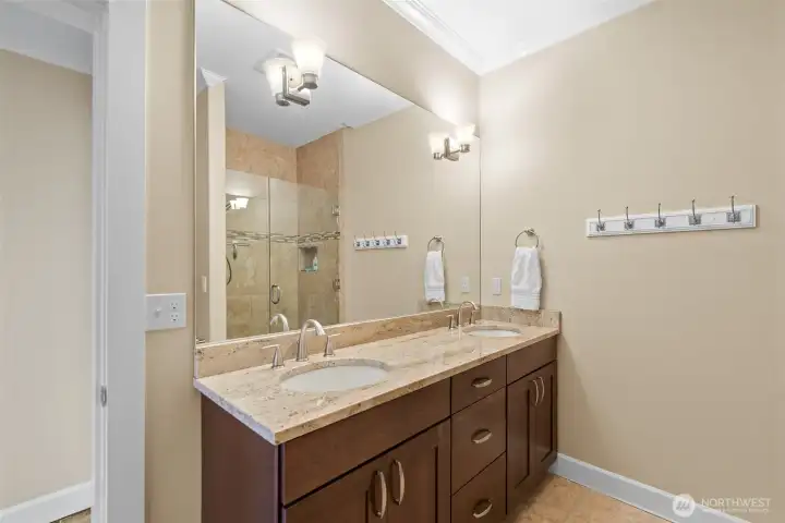The 3/4 bath located by guest bedrooms 1 &  2 has double sinks and a walk in shower.