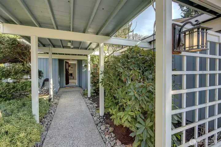 Be greeted with covered entryway by a lush manicured lawn and landscaping.