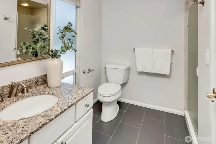 Updated bathroom with granite countertop.