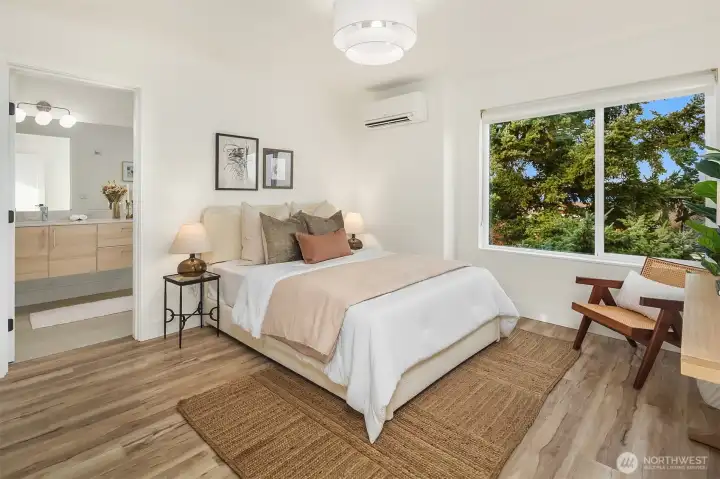 Primary bedroom with attached bath and walk-in closet.