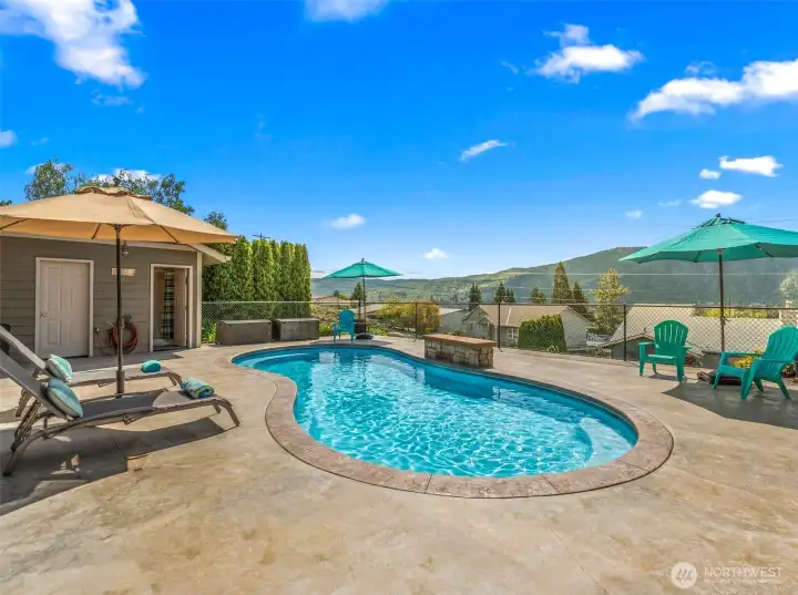 Salt water pool with water feature and pool house.
