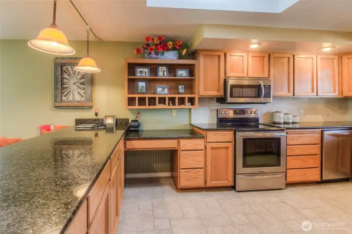 Spacious kitchen with hard surface counter tops and eating bar