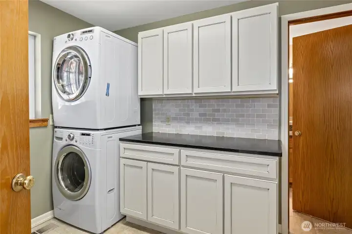 Laundry room with additional cupboards and folding area