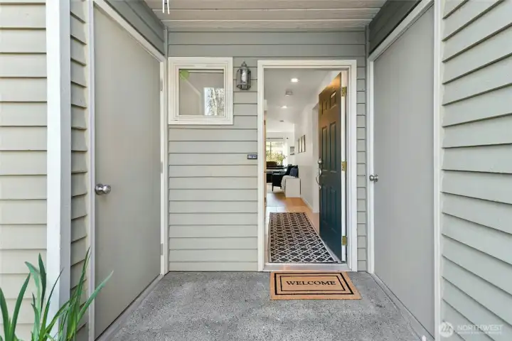 Cute covered porch, garage entry on right, storage on left.