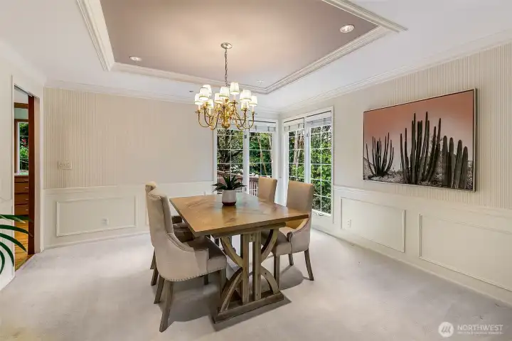Formal dining with wainscotting, tray ceilings and room for large gatherings