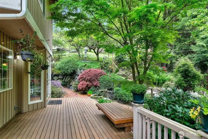 Backyard retreat with deck, lush gardens and water feature
