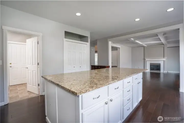 Open kitchen with a large granite island, plenty of storage, and easy flow into the main living space with plenty of storage space.