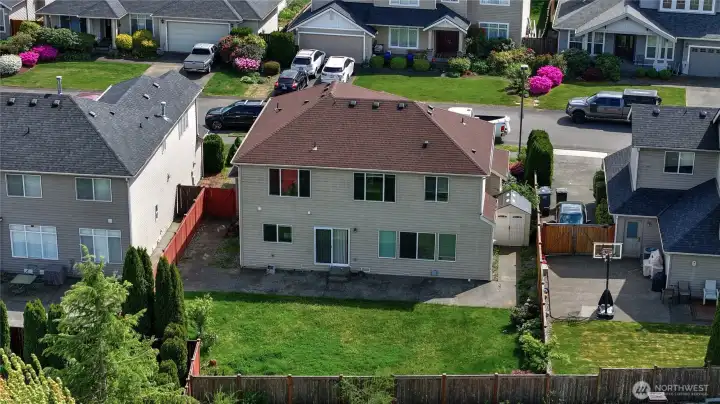 Aerial view of the spacious fully fenced backyard with plenty of room for entertaining, gardening, pets, and outdoor living.