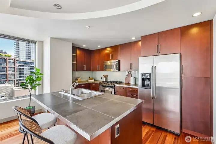 Open Kitchen with Natural Stone & Cherry Surfaces Open Kitchen with Natural Stone & Cherry Surfaces