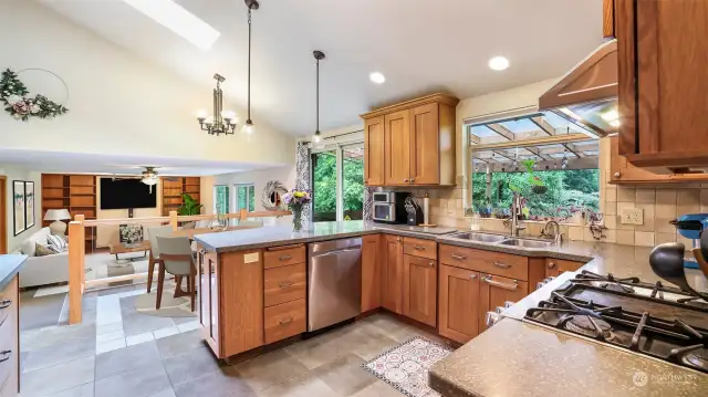 Kitchen features stainless steel appliances, quartz countertops, window above the sink and sizable peninsula with room for seating. **Family Room Virtually Staged**