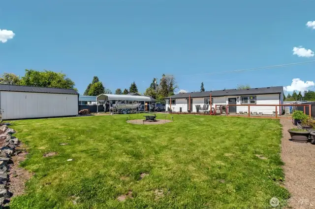 Large Fully fenced back yard with storage shed and a carport cover