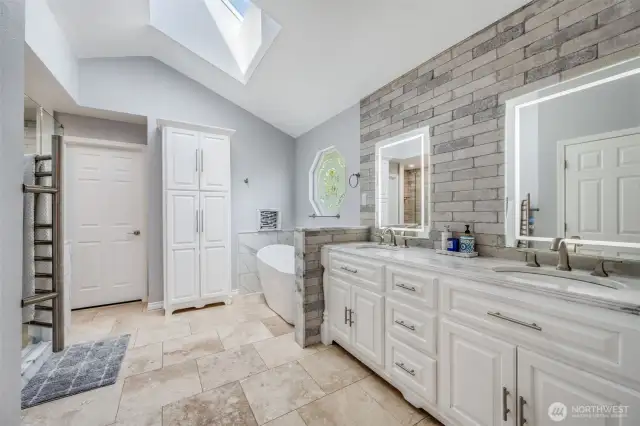 Primary suite luxury bathroom. Heated floors and towel bar. Lavish tile work