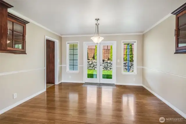 French doors lead out to covered patio and fully fenced backyard
