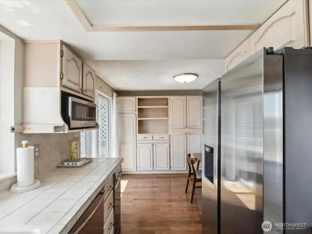 Elegant kitchen with stainless steel and lots of storage.