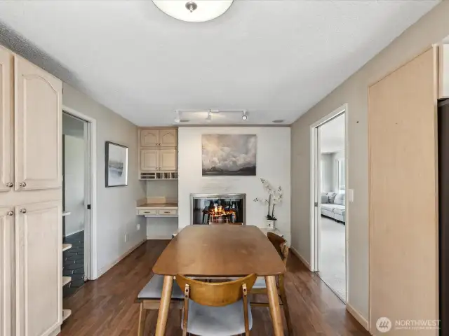 Dining room with hardwood flooring, fireplace, lots of storage, nook, and pocket doors.