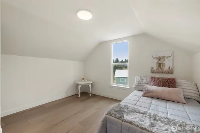 Light filled secondary bedroom offers a comfortable space perfect for kids or guests