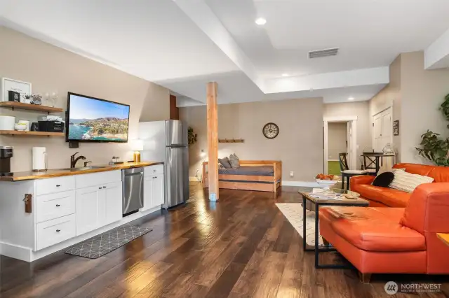 Effortless living starts here with a fully equipped Airbnb kitchenette, complete with dishwasher, sink, and fridge. Open shelving keeps it light and inviting, and the 10-foot ceilings make the space feel bright and spacious.