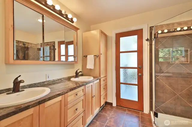 Heated floors are such a joy in the primary bath. Beautiful marble countertops add to the warmth. If you love the heat, hit the hot tub through the glass doors.