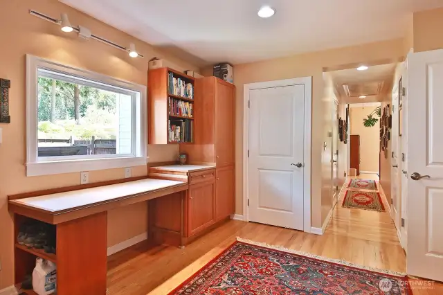A large Laundry/Mud/Office area provides plenty of room for hobbies and crafts of all kinds. The white countertop opens up to twice its size for a large sewing/crafts table.