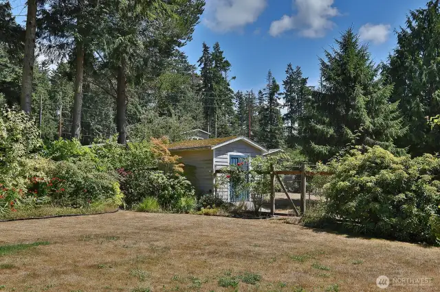 A fully enclosed garden space includes a potting/tool shed.