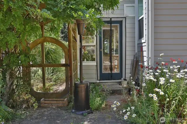 Side gate to backyard and entrance to the attached greenhouse room.