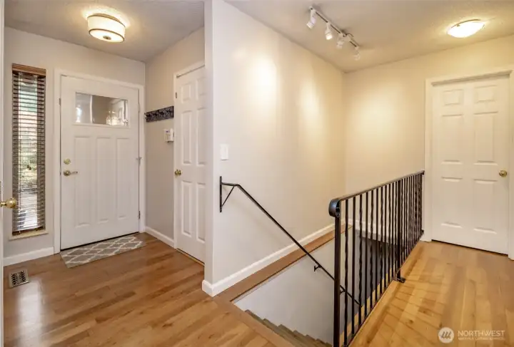 Entrance to home, door to Garage and stairs/hallway.