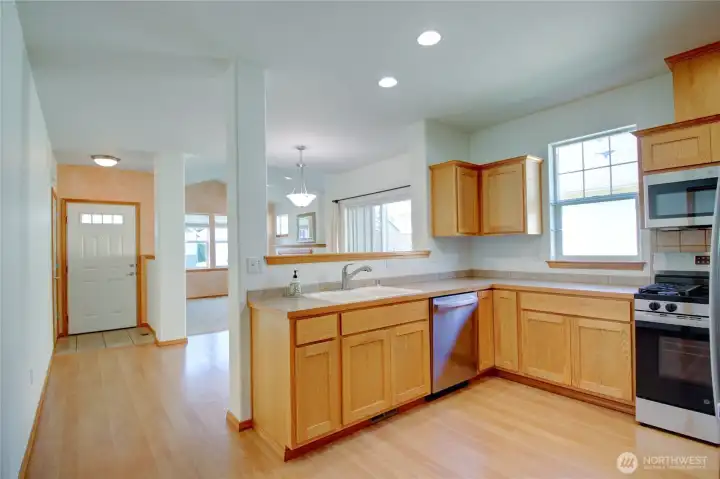 Bright open kitchen, dining and living spaces.