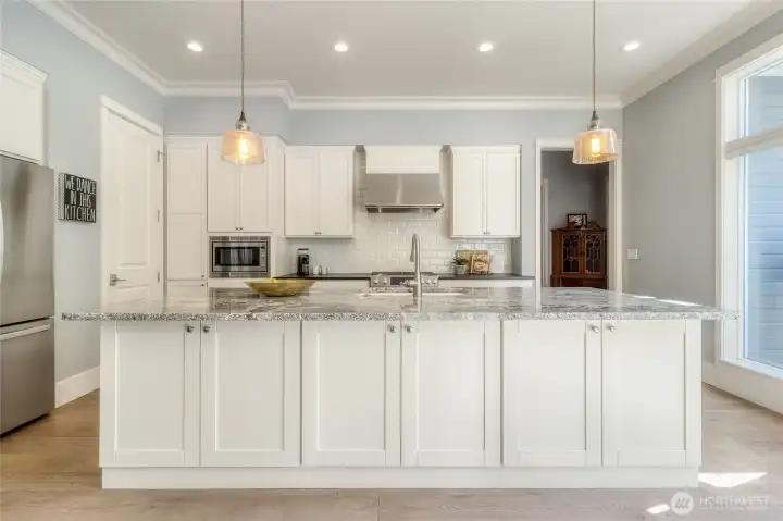 Granite countertops, walk-in Pantry and stainless steel appliances in this open kitchen