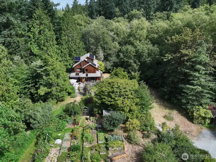 From above. Great perspective of the gardens. You can see a glimpse of the garage along the right edge of this photo. The path to The Whidbey Institute is located on the south eastern part of the acreage.
