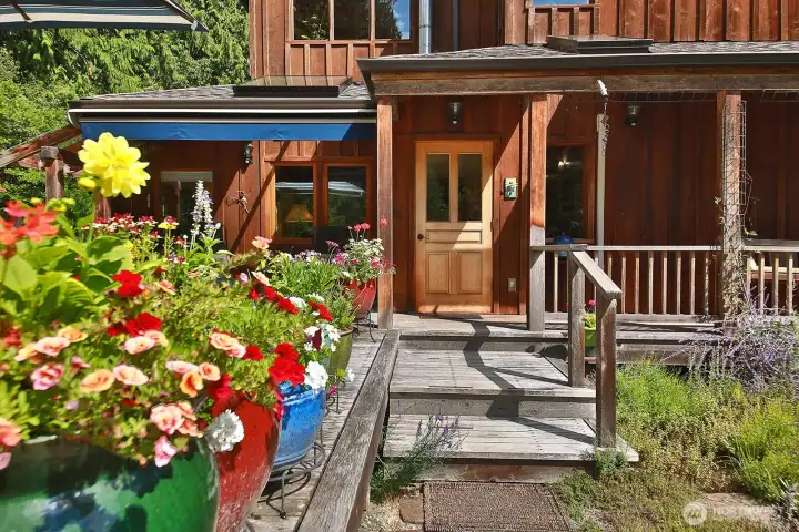 Let's go inside. A foyer with ceramic tile provides a warm welcome to the open living/kitchen/dining area. Stairs to the upper levels are to the right upon entry.