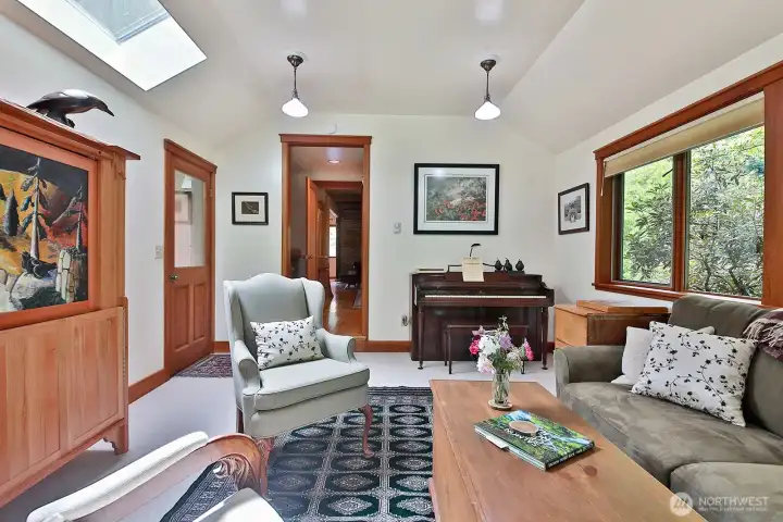 One of the additions, designed for the potential of being an additional living space for family (if needed) with a separate entrance. We are looking back through the small hallway with the full bath that connects to the Kitchen.